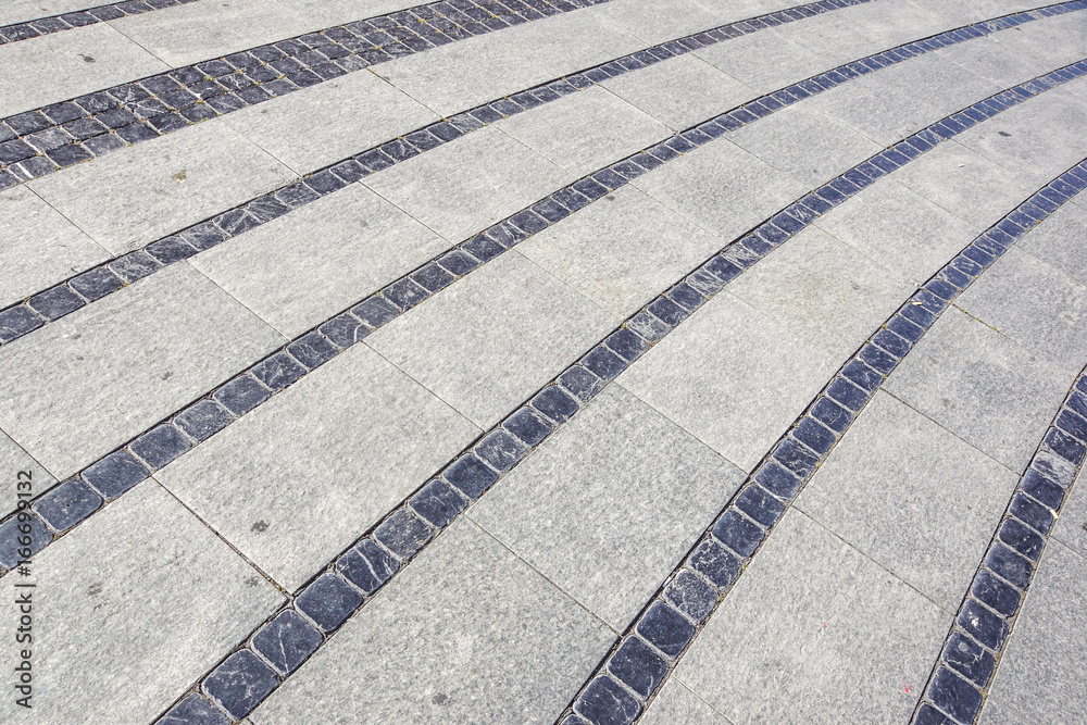 Fototapeta premium Stone pavement texture. Granite cobble stoned pavement background. Abstract background of old cobblestone pavement