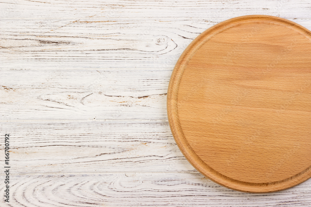 Empty round cutting board on a white kitchen top. Empty round cutting board on a white kitchen top.
