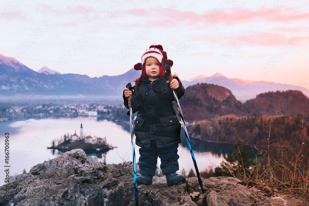 Child with trekking poles on Bled Lake,  Slovenia, Europe