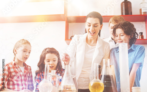 Group of four pupils standing around their teacher