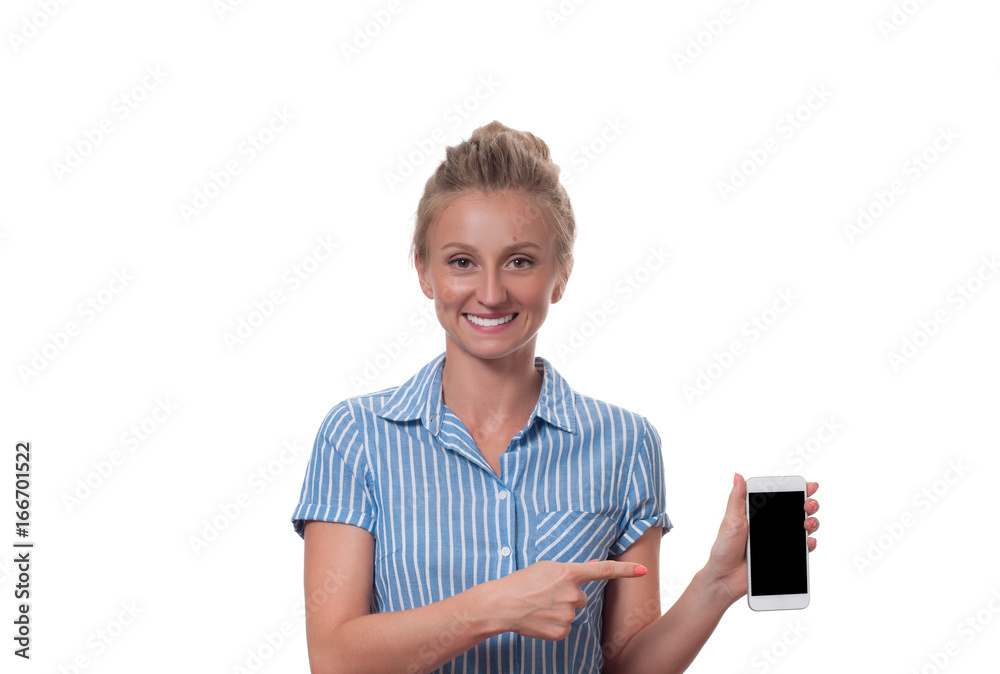 Smiling woman is pointing on cell phone standing on white background. Smiling woman is pointing on cell phone standing on white background.