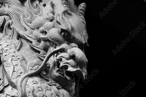 Monocrhome Dragon sculpture on stone pole in Wong Tai Sin