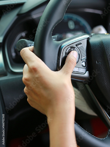Hand using Car convenient function on steering wheel. © zilvergolf