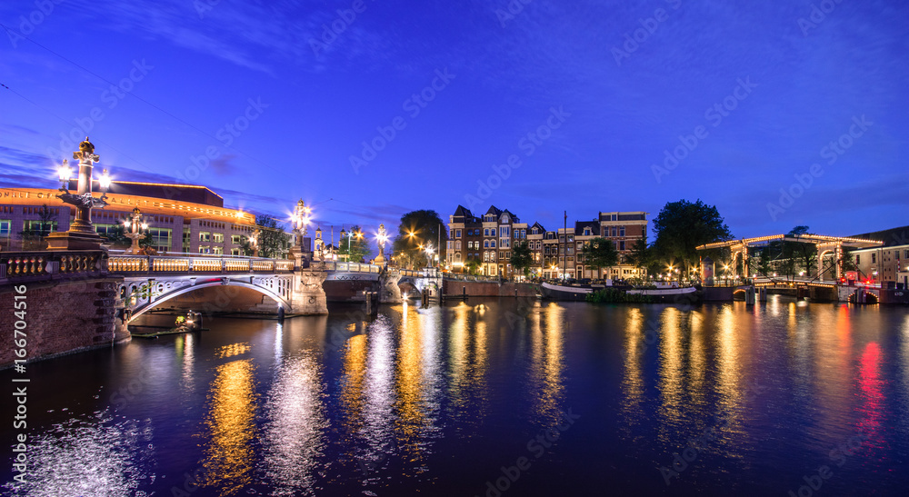 Amsterdam at night, with flowers and bicycles on the bridge, Holland, Netherlands. Amsterdam at night, with flowers and bicycles on the bridge, Holland, Netherlands.