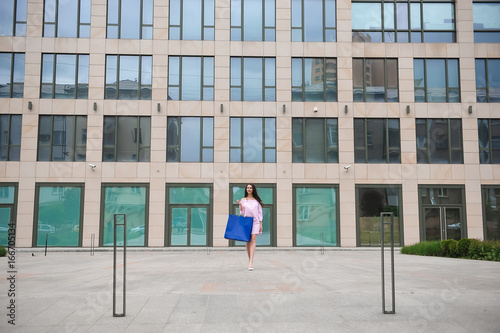 Wallpaper Mural Beautiful happy girl goes shopping in the city. Torontodigital.ca