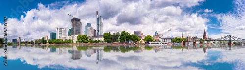 Summer panorama of the financial district with sky towers reflected on the river surface in Frankfurt am Main  Germany