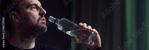 Man drinking alcohol from bottle