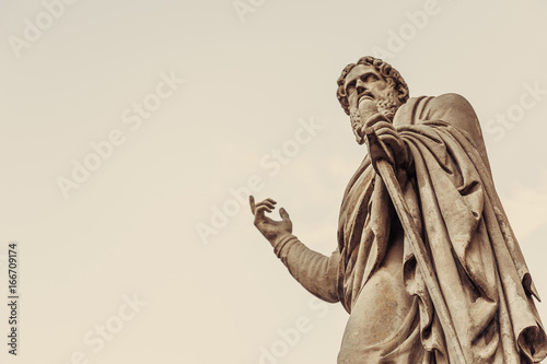 Vintage statue points finger up, copy space for your text
