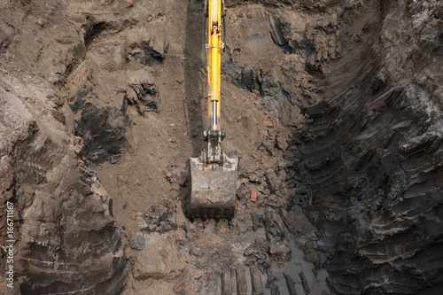 Top view of an excavator digging in the ground.