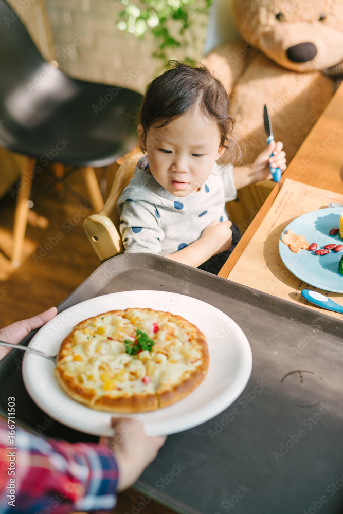 Toddler girl having lunch