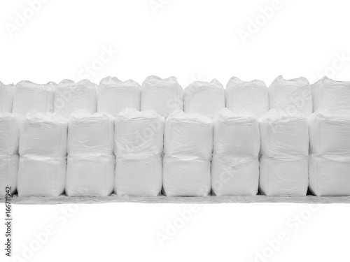 Stacking of sugar in jumbo bags isolated on white