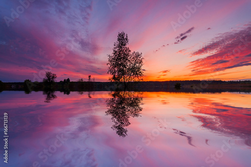 Obraz na plátne Reflection of a beautiful dawn sky in a river