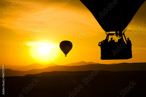 Hot balloon silhouette with sunrise sky background