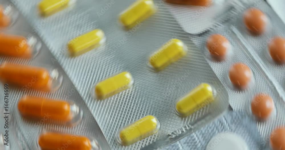 Pills and drugs turning. Medicine, pills and tablets with blister packs turning. Close up of many different spinning drugs Pills and drugs turning. Medicine, pills and tablets with blister packs turning. Close up of many different spinning drugs