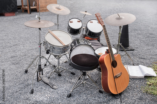 Music instrument / View of drum and guitar on the ground.