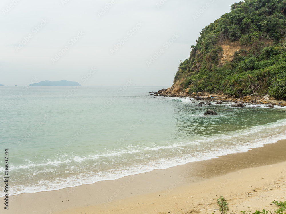 Tropical sand beach with sea and mountain