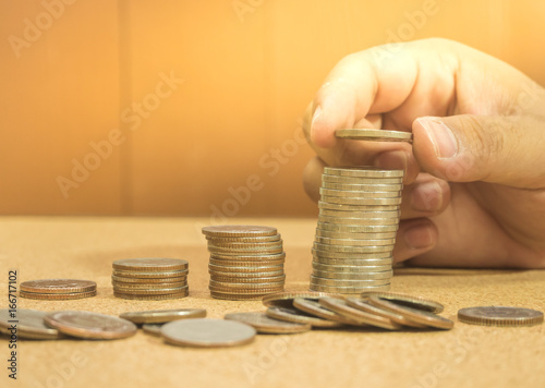 Saving money concept preset by hand putting money coin stack growing business photo
