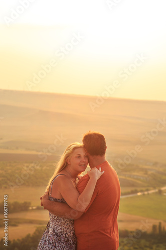 Loving couple on a rock top. © lizavetta