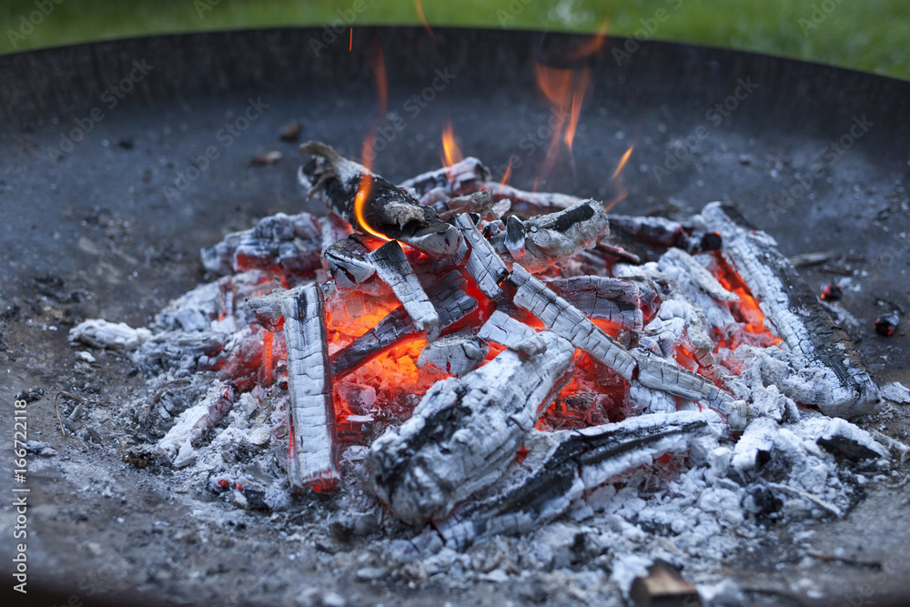 Burning wood in a grill