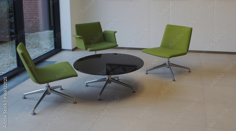 business meeting room three green chairs and round table