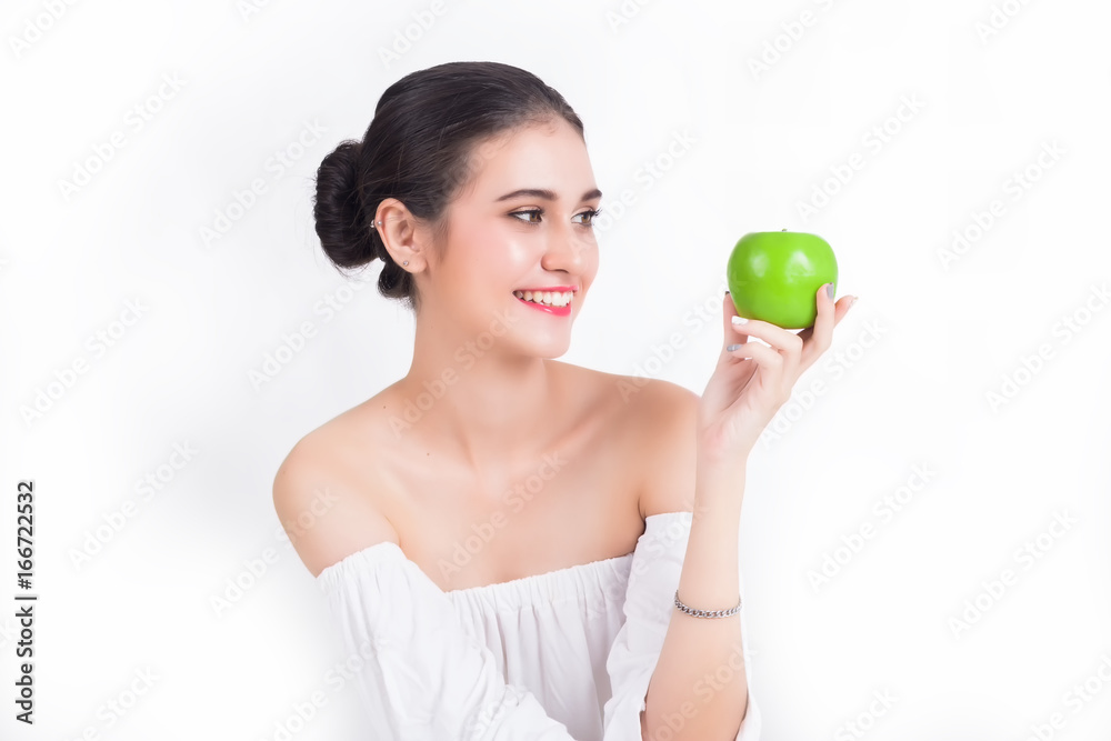 Beautiful Girl Looking at Green Apple Health and Healthy Concepts On a white background Beautiful Girl Looking at Green Apple Health and Healthy Concepts On a white background