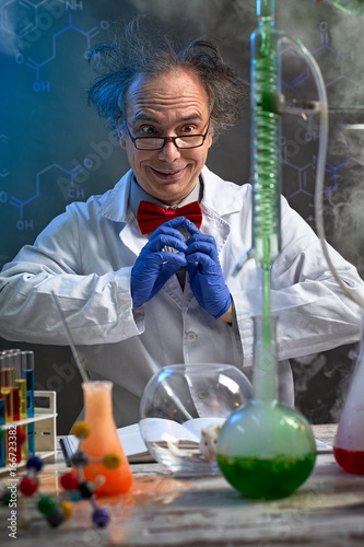 Happy crazy chemist looking in experiment