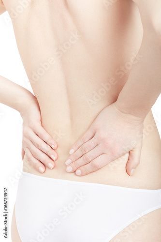 Young woman suffering from pain in lower back isolated on white  clipping path