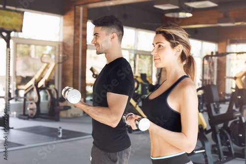 Young couple exercise together in gym healthy lifestyle