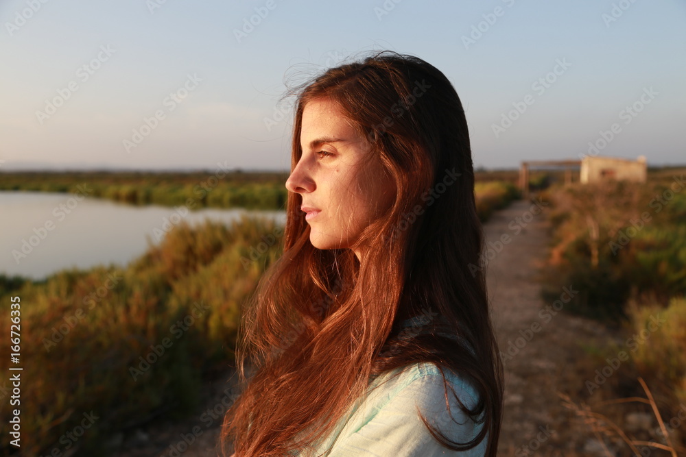 Side portrait of a woman in a natural landscape Side portrait of a woman in a natural landscape