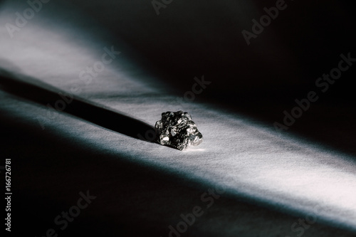 Pyrite, Commonly Known As Fool's Gold, Illuminated By Beam Of Light photo