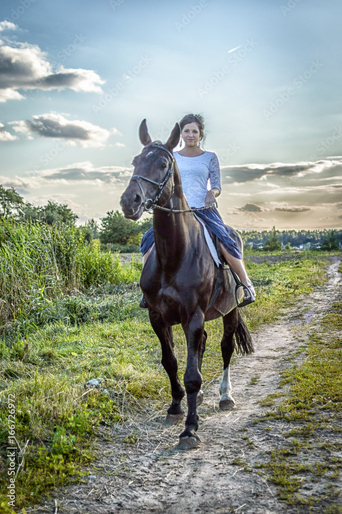 The girl goes for a drive on a horse