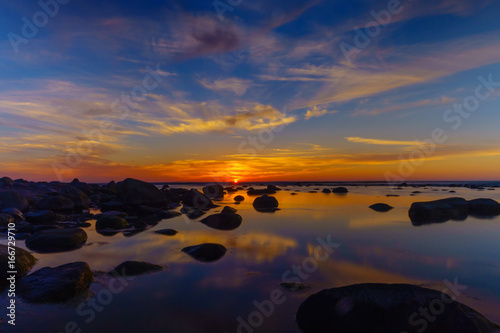 Sunset over the sea  stones at foreground