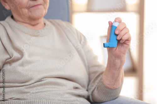 Elderly woman with inhaler ...