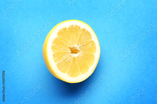 Half of delicious fresh lemon on color background