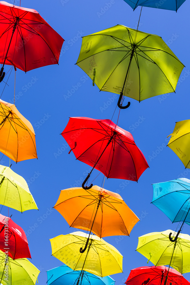 Suspended umbrellas swaying in the wind