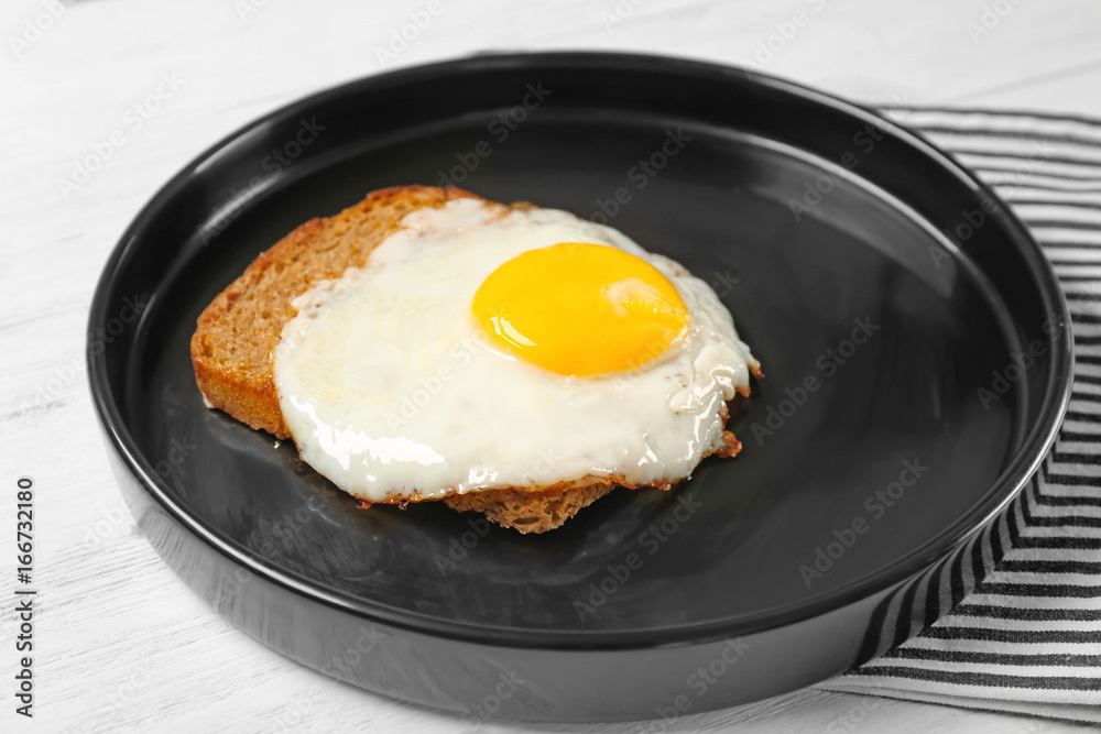 Delicious over easy egg with bread on kitchen table Delicious over easy egg with bread on kitchen table