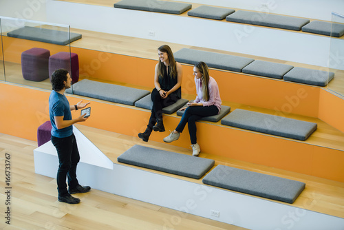 Coworkers having a meeting in a modern office auditorium