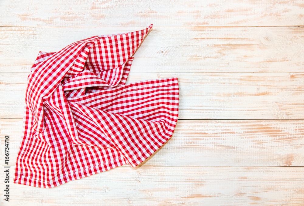 The checkered tablecloth on wooden table. The checkered tablecloth on wooden table.