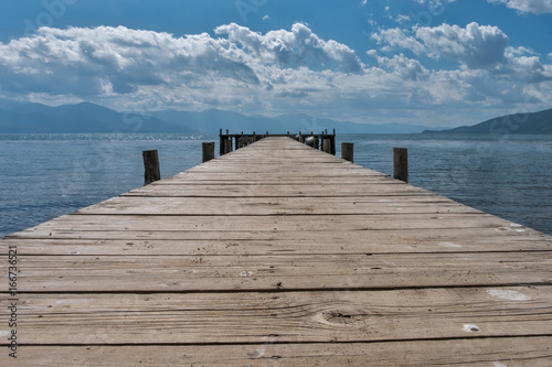 Fototapeta Naklejka Na Ścianę i Meble -  mpty wooden jetty on the lake shore