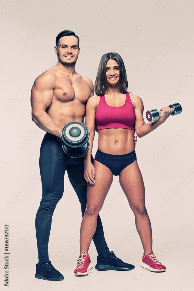 Man and woman with dumbbells