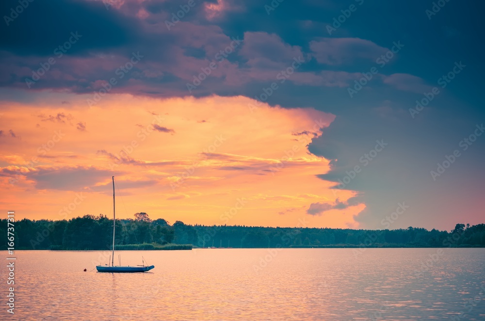 Boat on the water. Evening landscape by the lake.
