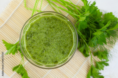 parsley and celery juice in glass on table