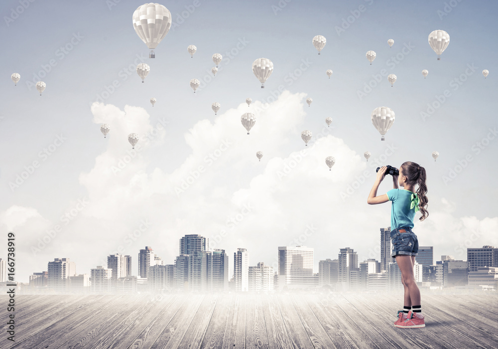 Concept of careless happy childhood with girl looking in binocul Concept of careless happy childhood with girl looking in binocul