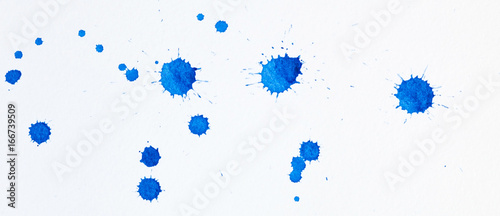 Blue watercolor paint blots on white parer as background