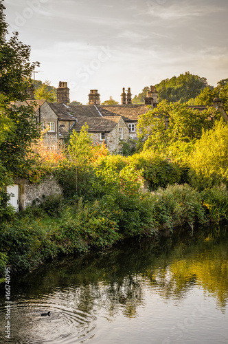 Stone houses by a river in the English countyside photo