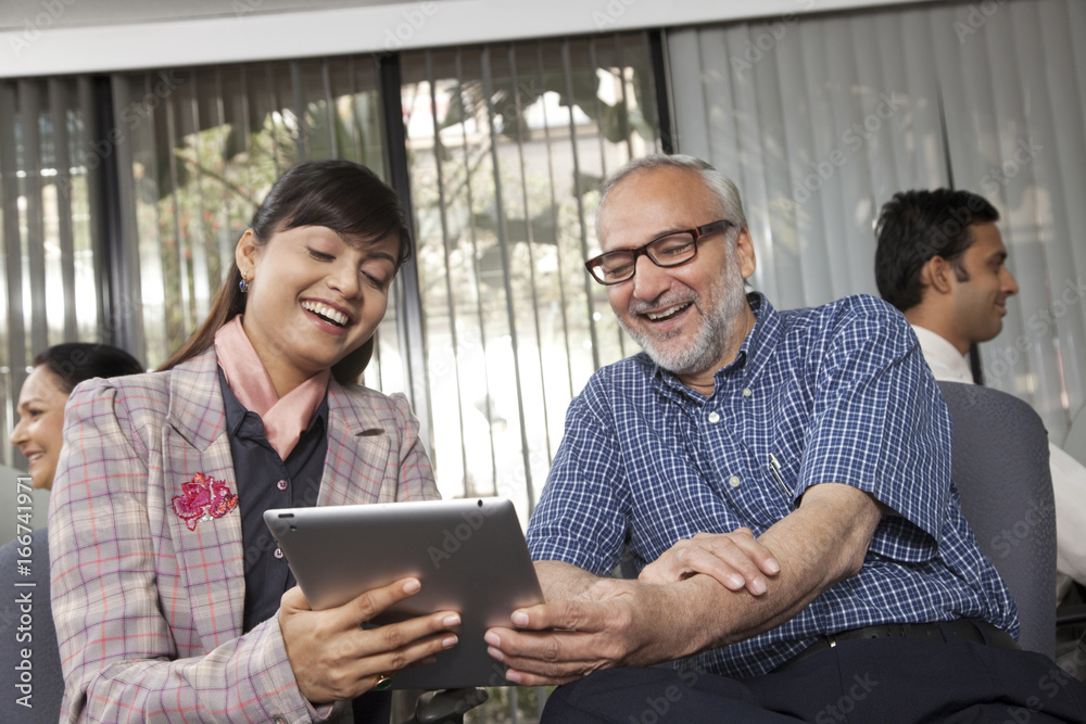 Senior man and woman looking at a tablet