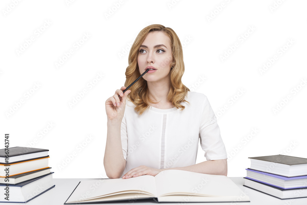 Red haired student at a table with books, isolated Red haired student at a table with books, isolated