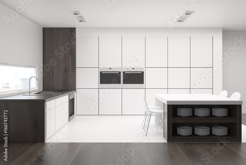 White kitchen with a table and countertops dark © ImageFlow