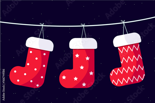 Christmas socks hanging on a wire with starry sky background