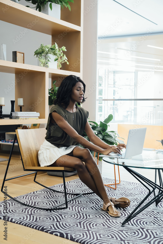 Business woman working on laptop in modern office space Business woman working on laptop in modern office space